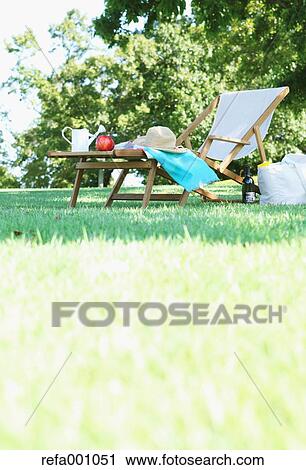 Stock Image - Deck chair in a city park. Fotosearch