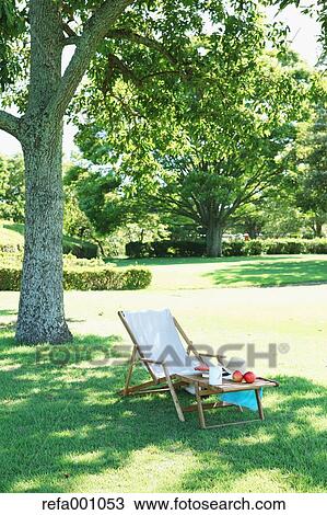 Stock Image - Deck chair in a city park. Fotosearch
