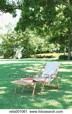 Stock Image - Deck chair in a city park. Fotosearch