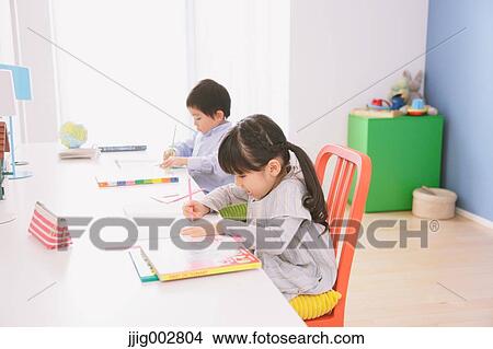 Picture - Elementary age brother and sister doing homework at their desk. Fotosearch