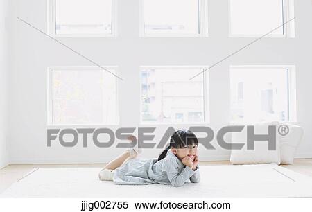 Elementary age girl laying on the floor by the window and smiling at camera View Large Photo Image Stock Photography - Elementary age girl laying on the floor by the window and smiling at camera. Fotosearch
