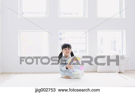 Elementary age girl playing with an earth ball by the window View Large Photo Image Stock Image - Elementary age girl playing with an earth ball by the window. Fotosearch