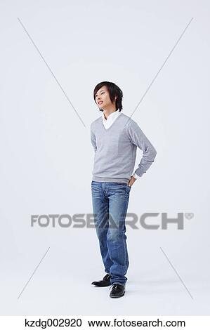 Stock Image - Full body view of young man wearing jeans. Fotosearch