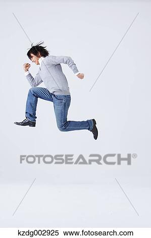 Stock Photography - Full body view of young man wearing jeans. Fotosearch