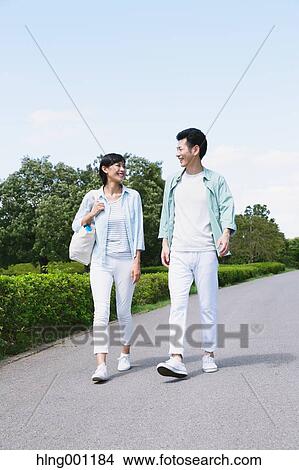 Picture - Happy Japanese couple in a park. Fotosearch