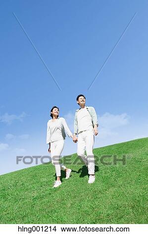 Picture - Happy Japanese couple in a park. Fotosearch