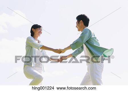 Happy Japanese couple in a park View Large Photo Image Picture - Happy Japanese couple in a park. Fotosearch
