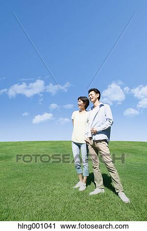 Stock Image - Happy Japanese couple in a park. Fotosearch