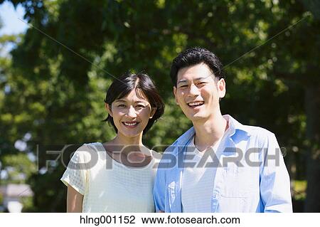 Happy Japanese couple in a park View Large Photo Image Stock Image - Happy Japanese couple in a park. Fotosearch