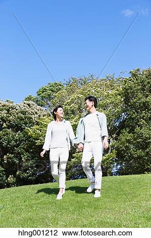 Happy Japanese couple in a park View Large Photo Image Stock Image - Happy Japanese couple in a park. Fotosearch