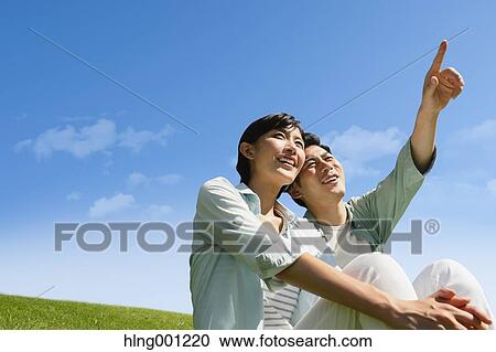 Happy Japanese couple in a park View Large Photo Image Stock Image - Happy Japanese couple in a park. Fotosearch