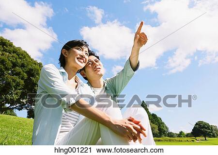 Happy Japanese couple in a park View Large Photo Image Stock Image - Happy Japanese couple in a park. Fotosearch