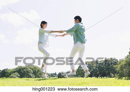 Happy Japanese couple in a park View Large Photo Image Stock Image - Happy Japanese couple in a park. Fotosearch