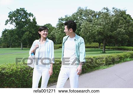 Happy Japanese couple in a park View Large Photo Image Stock Image - Happy Japanese couple in a park. Fotosearch