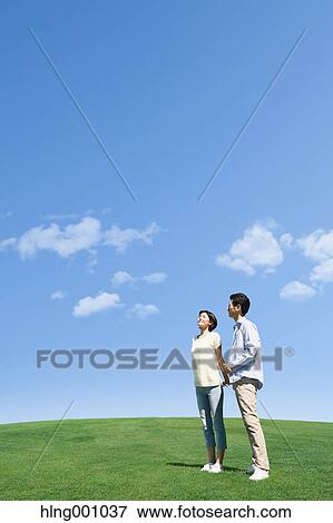 Stock Photo - Happy Japanese couple in a park. Fotosearch