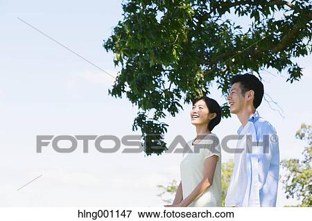 Stock Photo - Happy Japanese couple in a park. Fotosearch