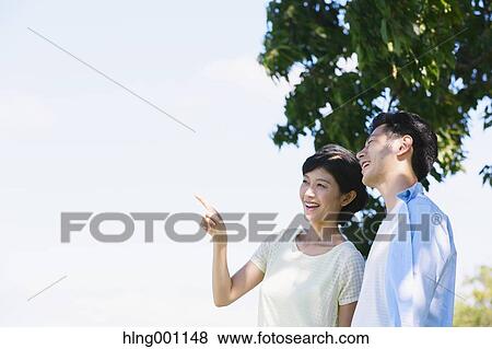 Happy Japanese couple in a park View Large Photo Image Stock Photo - Happy Japanese couple in a park. Fotosearch