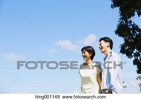 Happy Japanese couple in a park View Large Photo Image Stock Photo - Happy Japanese couple in a park. Fotosearch