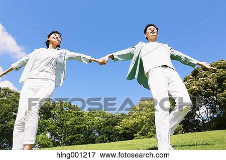 Happy Japanese couple in a park View Large Photo Image Stock Photo - Happy Japanese couple in a park. Fotosearch