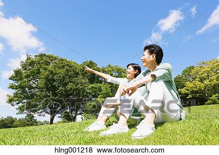 Stock Photo - Happy Japanese couple in a park. Fotosearch