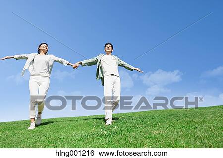 Happy Japanese couple in a park View Large Photo Image Stock Photograph - Happy Japanese couple in a park. Fotosearch