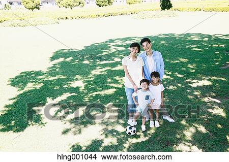 Picture - Happy Japanese family in a city park. Fotosearch