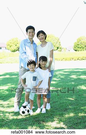 Picture - Happy Japanese family in a city park. Fotosearch