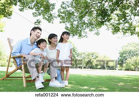 Happy Japanese family in a city park View Large Photo Image Picture - Happy Japanese family in a city park. Fotosearch
