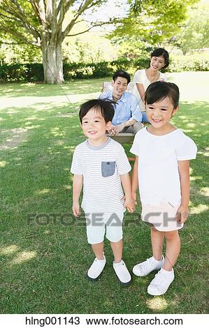 Happy Japanese family in a city park View Large Photo Image Stock Image - Happy Japanese family in a city park. Fotosearch