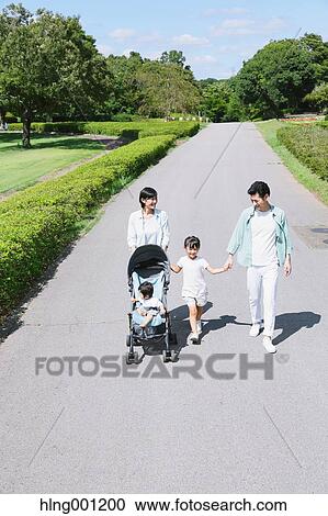 Stock Image - Happy Japanese family in a city park. Fotosearch