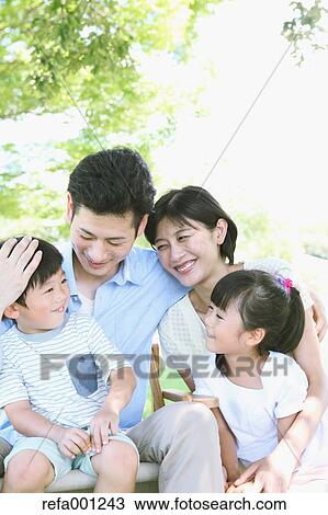 Happy Japanese family in a city park View Large Photo Image Stock Image - Happy Japanese family in a city park. Fotosearch