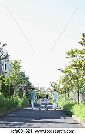 Stock Image - Happy Japanese family in a city park. Fotosearch