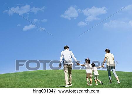 Stock Photo - Happy Japanese family in a city park. Fotosearch