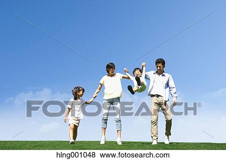 Stock Photo - Happy Japanese family in a city park. Fotosearch