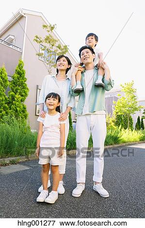 Stock Photo - Happy Japanese family in a city park. Fotosearch