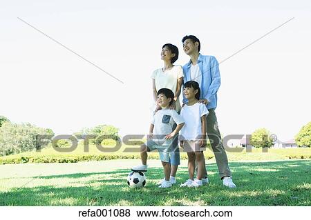 Stock Photo - Happy Japanese family in a city park. Fotosearch