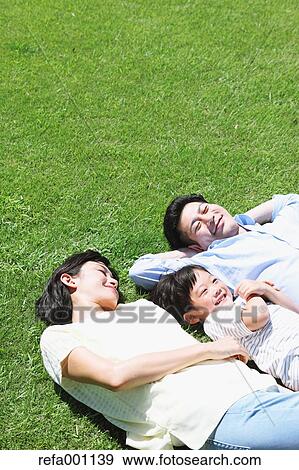 Stock Photo - Happy Japanese family in a city park. Fotosearch