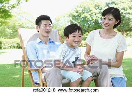 Happy Japanese family in a city park View Large Photo Image Stock Photo - Happy Japanese family in a city park. Fotosearch