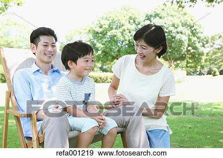 Stock Photo - Happy Japanese family in a city park. Fotosearch