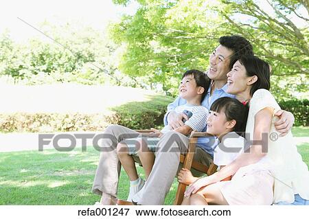Stock Photo - Happy Japanese family in a city park. Fotosearch