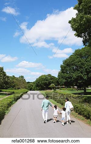 Stock Photo - Happy Japanese family in a city park. Fotosearch