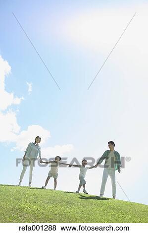 Stock Photo - Happy Japanese family in a city park. Fotosearch