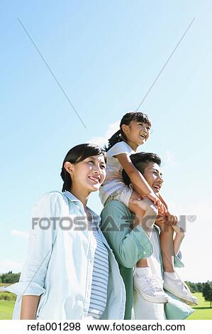 Stock Photo - Happy Japanese family in a city park. Fotosearch