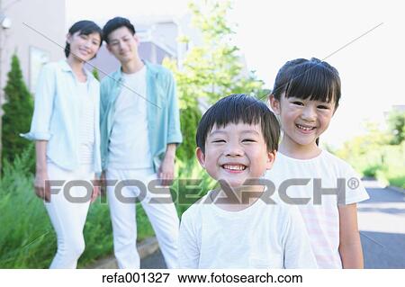 Stock Photo - Happy Japanese family in a city park. Fotosearch