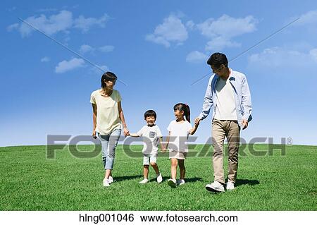 Stock Photograph - Happy Japanese family in a city park. Fotosearch