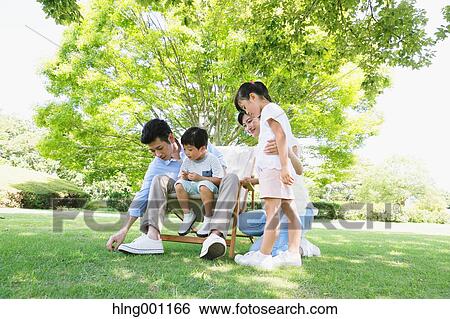 Happy Japanese family in a city park View Large Photo Image Stock Photograph - Happy Japanese family in a city park. Fotosearch