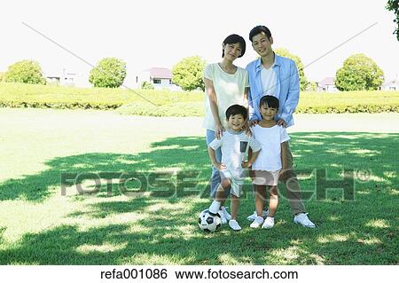 Stock Photograph - Happy Japanese family in a city park. Fotosearch