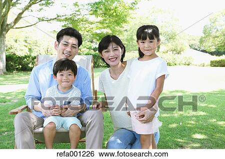 Happy Japanese family in a city park View Large Photo Image Stock Photograph - Happy Japanese family in a city park. Fotosearch