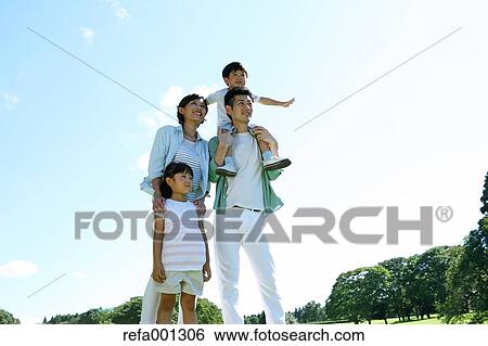 Stock Photograph - Happy Japanese family in a city park. Fotosearch