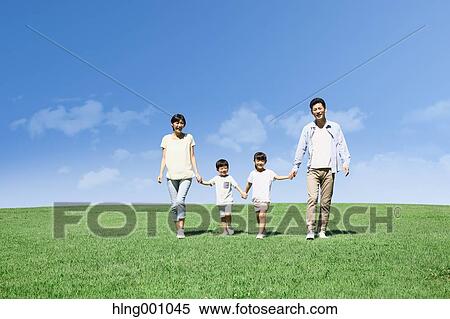 Stock Photography - Happy Japanese family in a city park. Fotosearch